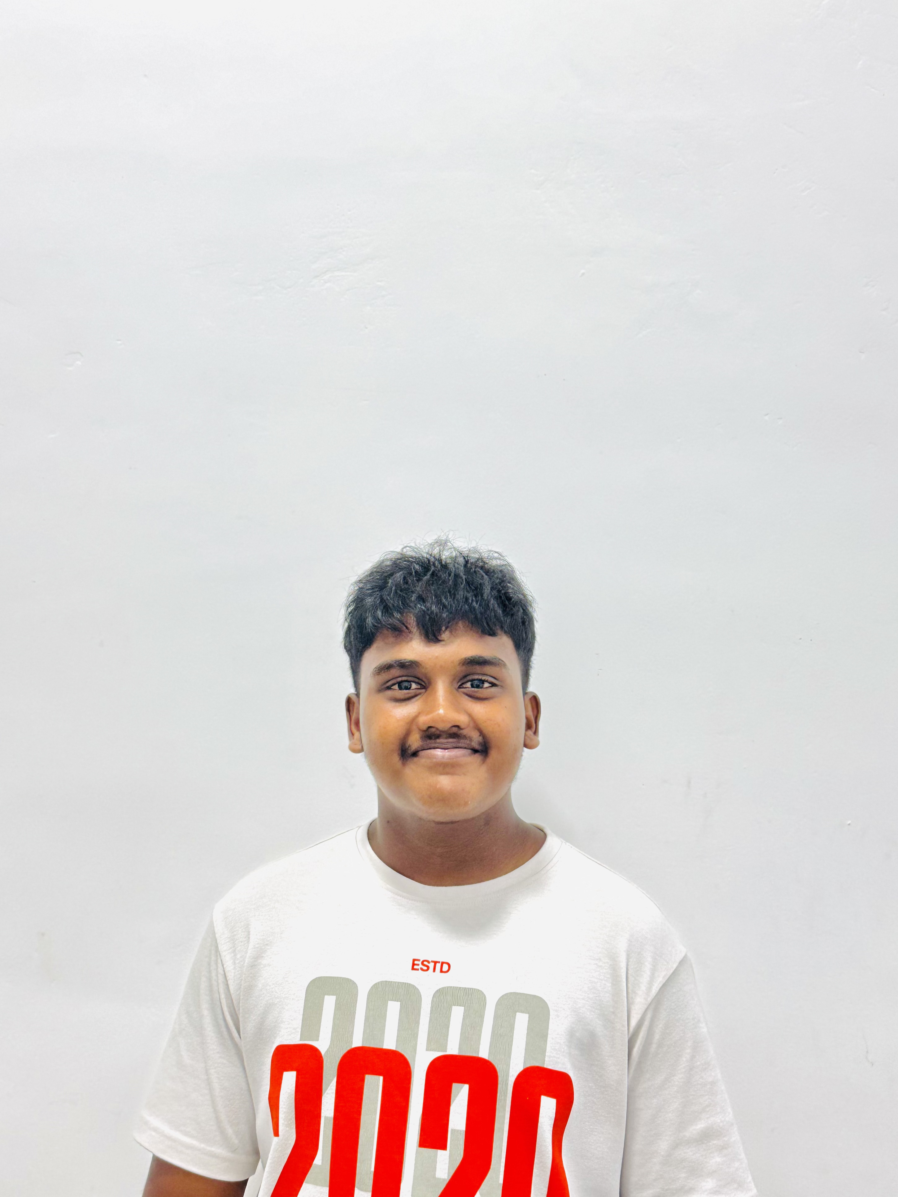 Esandu Kulatunga, portrait photograph holding a camera in Galle, Sri Lanka.